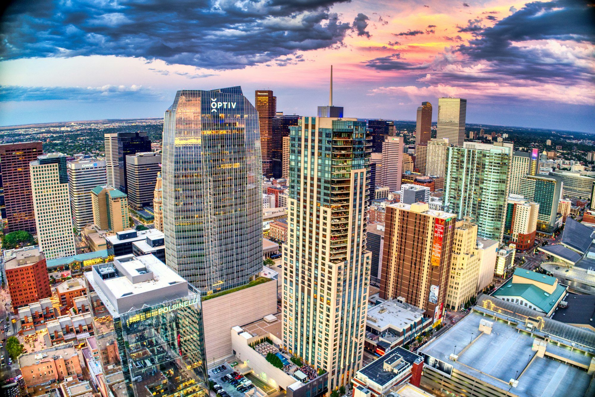 Denver high-rise buildings under white clouds and blue sky