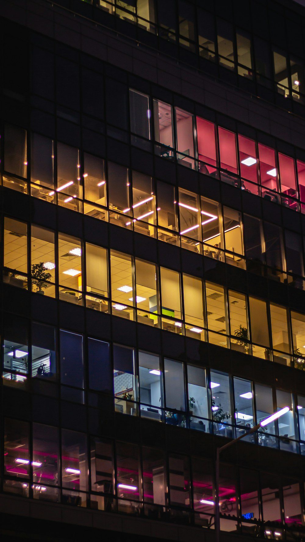 A high-rise with windows lit at night