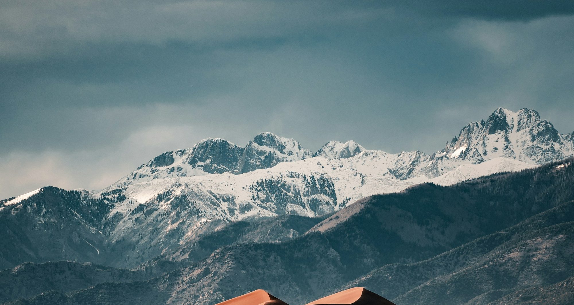 Snow-covered Rocky Mountain peaks under a Colorado sky